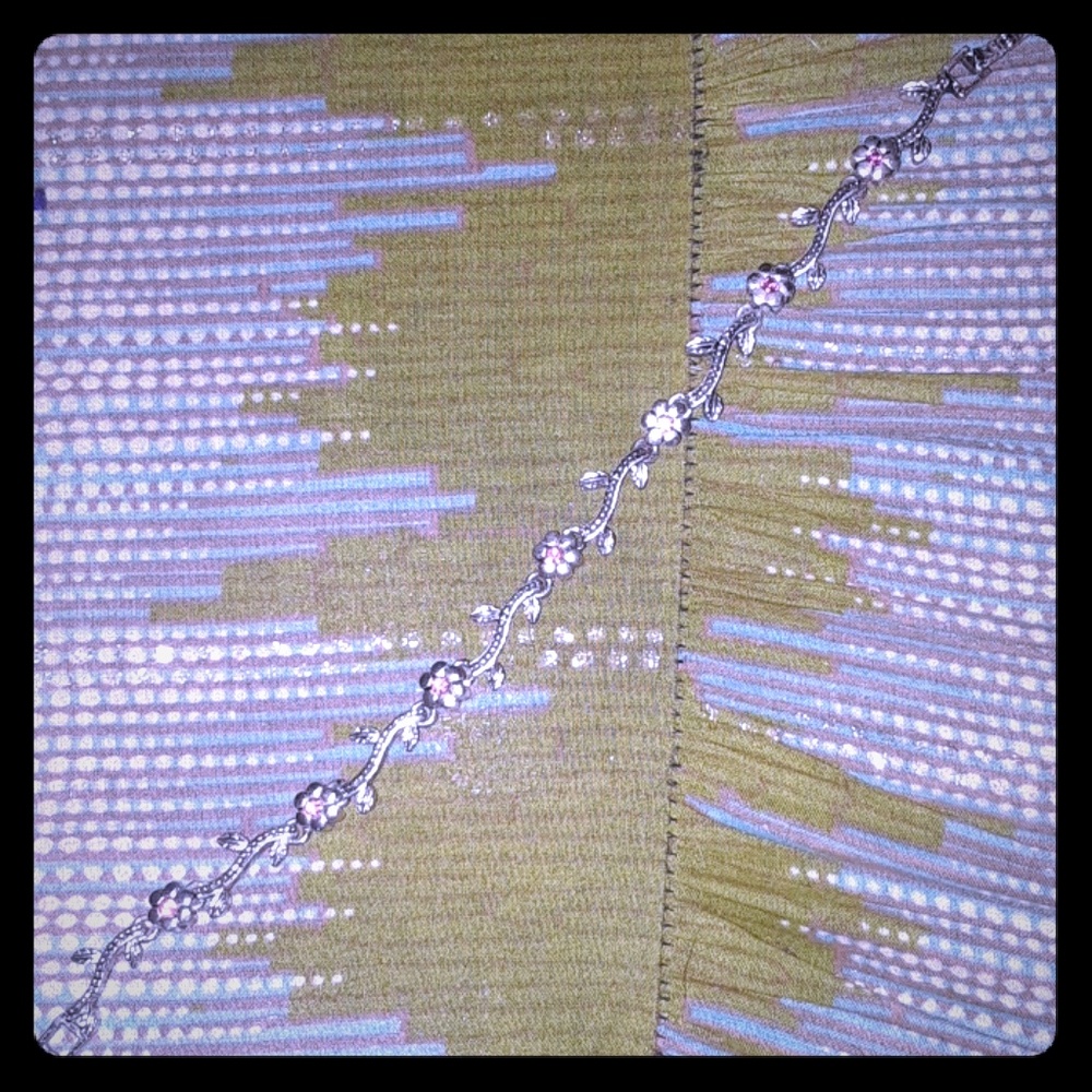 Silver toned flower bracelet with pink stones